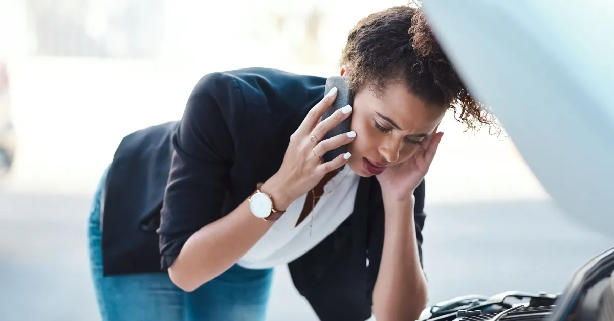 A woman calls for repairs after her car has broken down