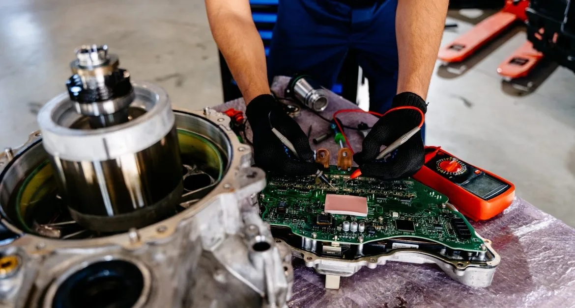An engineer carrying out electric car maintenance