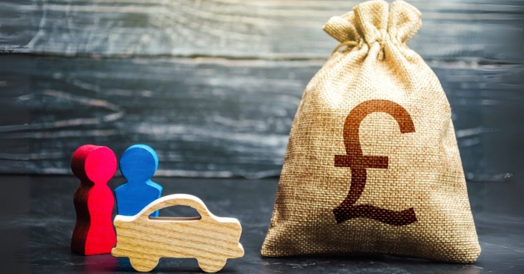 Two red and blue figures, a small wooden car, and a bag marked with a £ sign