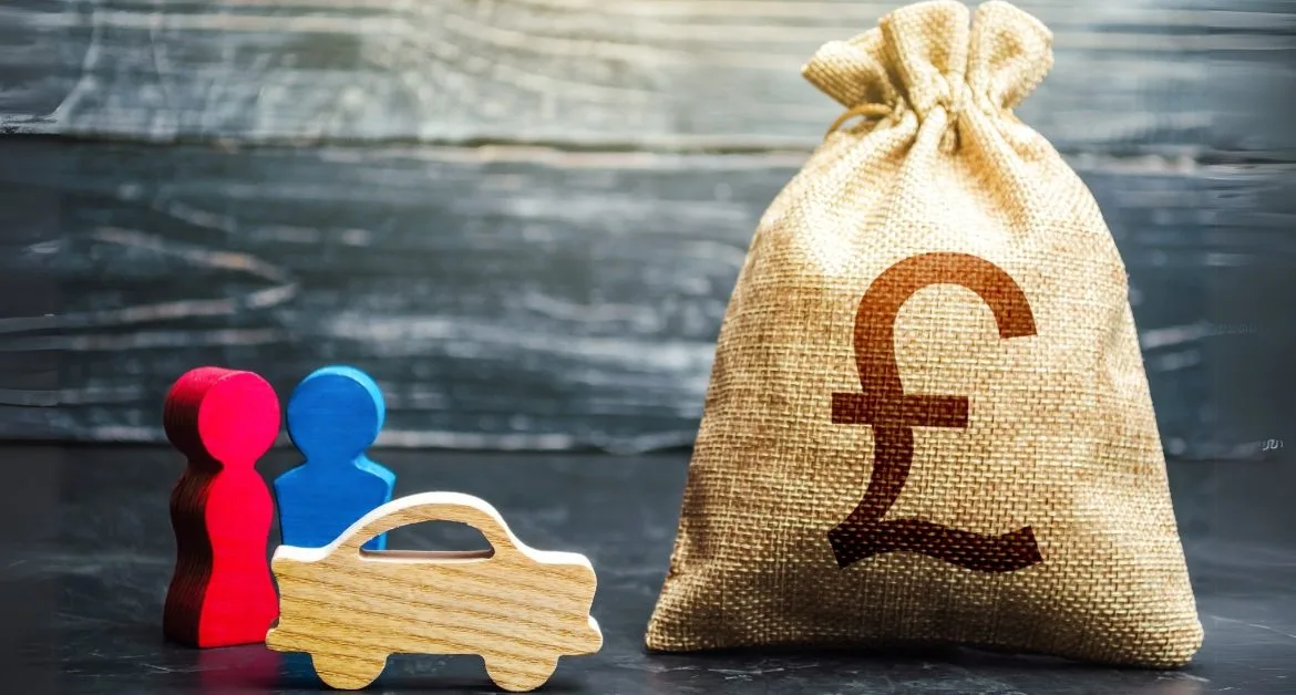 Two red and blue figures, a small wooden car, and a bag marked with a £ sign
