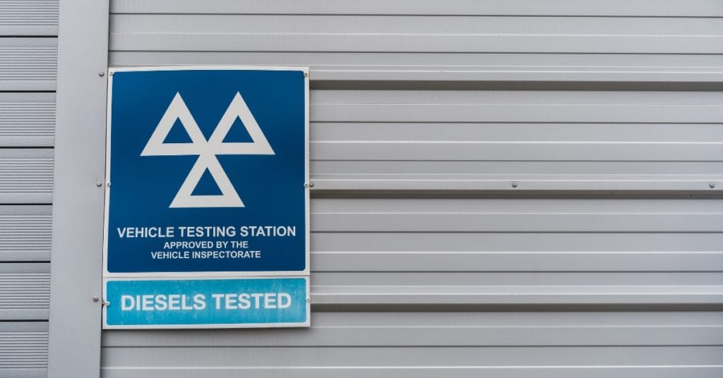 MOT testing station sign on the side of a building