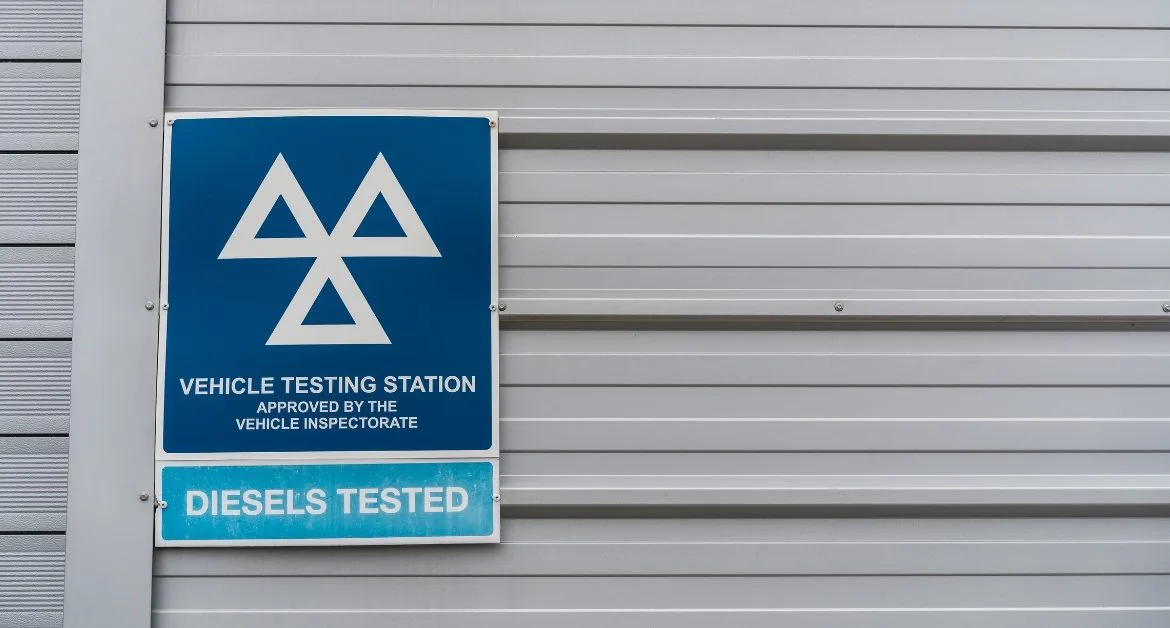 MOT testing station sign on the side of a building
