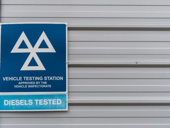 MOT testing station sign on the side of a building