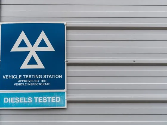MOT testing station sign on the side of a building