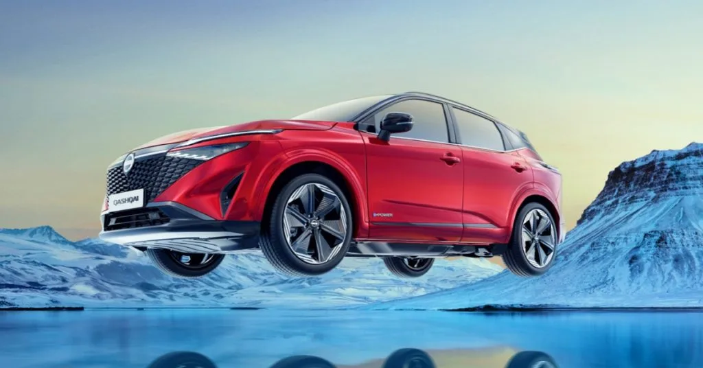 Red Nissan Qashqai e-POWER car positioned over a frozen landscape with snow-covered mountains in the background.