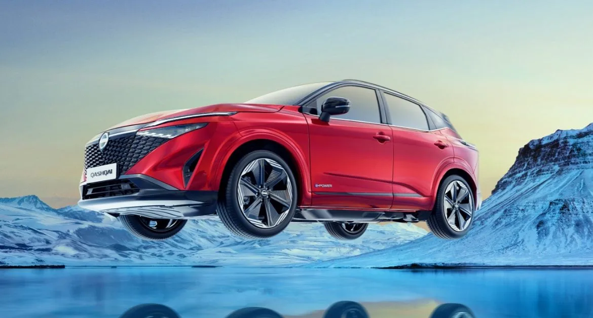 Red Nissan Qashqai e-POWER car positioned over a frozen landscape with snow-covered mountains in the background.