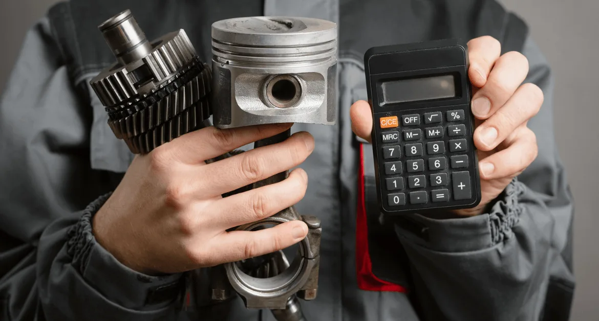 Mechanic holding car engine parts and a calculator, representing increasing car repair costs.
