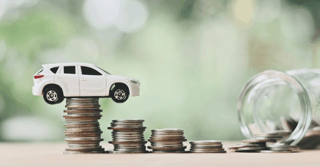 White toy SUV balanced on stacked coins with a jar spilling coins, representing cost of running a car and saving money.