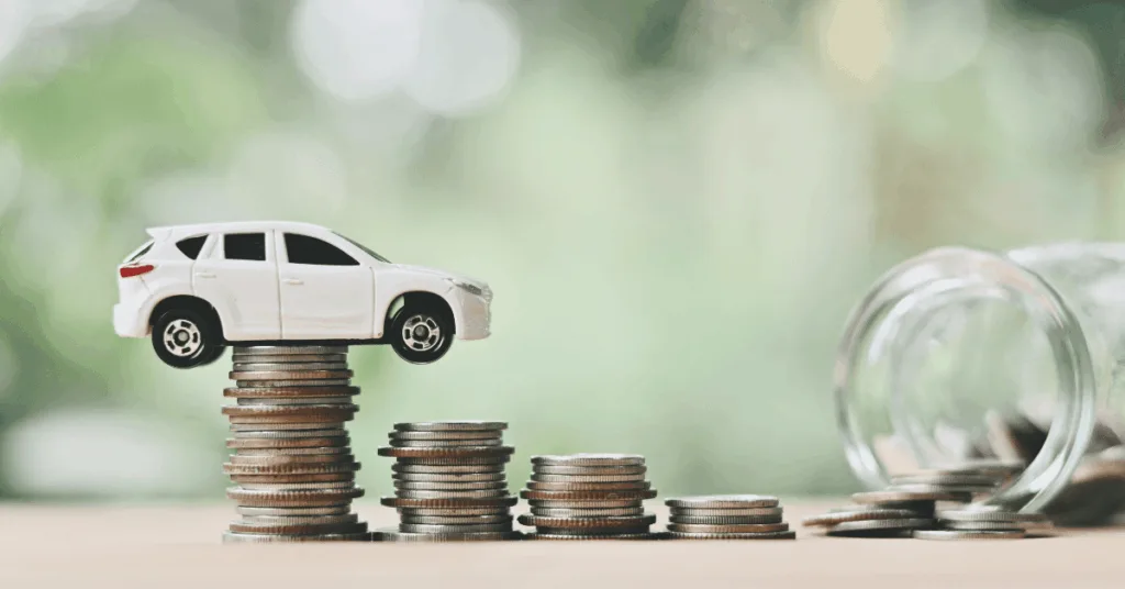 White toy SUV balanced on stacked coins with a jar spilling coins, representing cost of running a car and saving money.