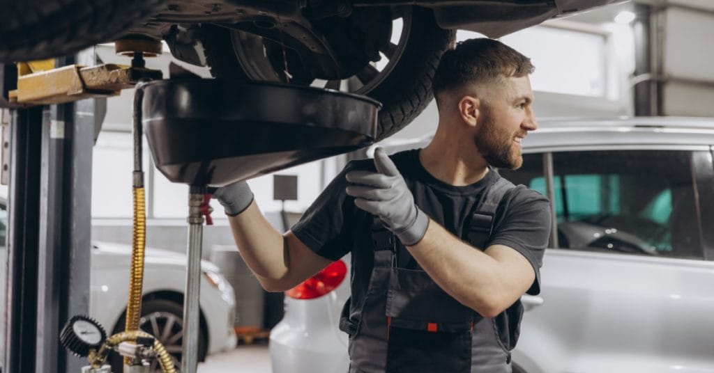 Mechanic carrying out car servicing with finance options, helping customers manage costs with a car repair payment plan, car repair monthly payments, and pay later car repairs.