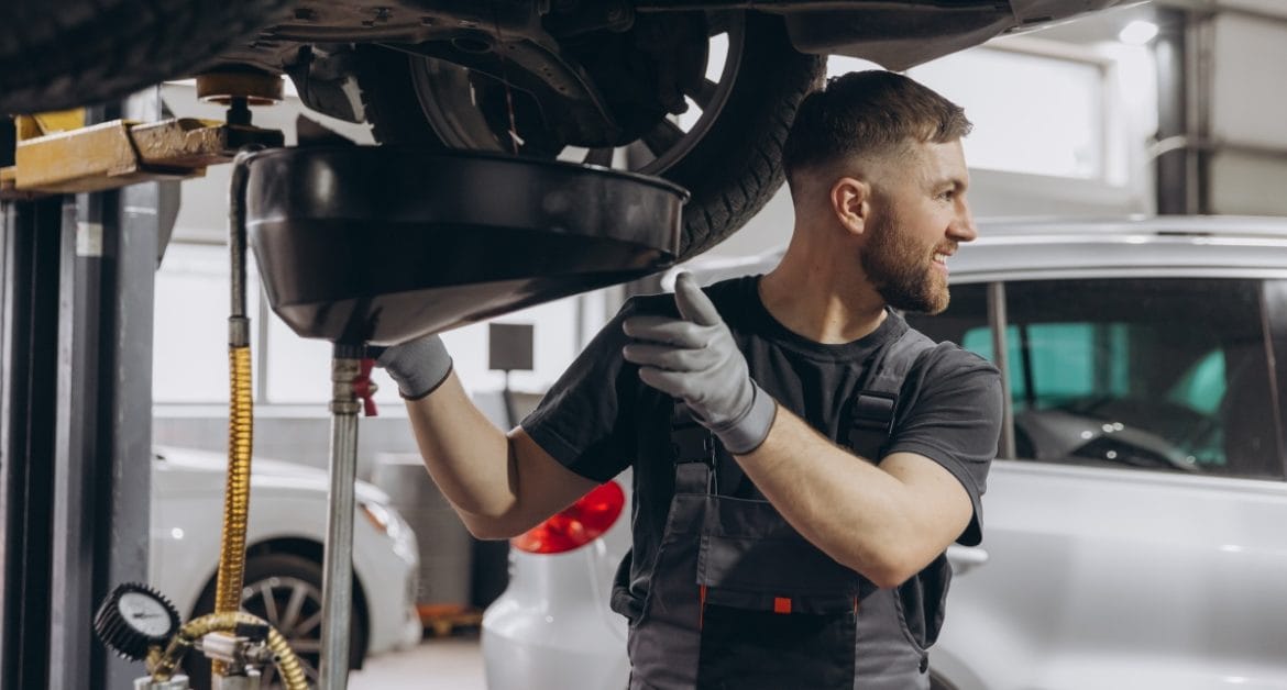 Mechanic carrying out car servicing with finance options, helping customers manage costs with a car repair payment plan, car repair monthly payments, and pay later car repairs.