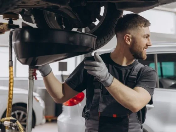 Mechanic carrying out car servicing with finance options, helping customers manage costs with a car repair payment plan, car repair monthly payments, and pay later car repairs.