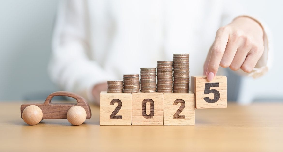 A row of coins stacked on wooden blocks marked 2025, used to show how the UK Budget could influence motoring costs and the automotive sector in the year ahead.
