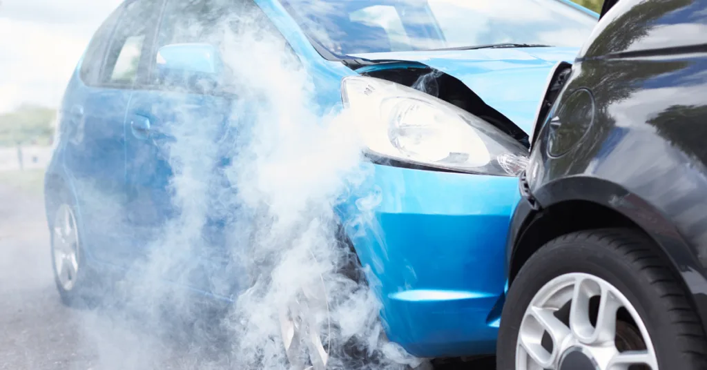 Car write-offs: Two cars involved in a collision, showing front-end damage and smoke rising from one vehicle.