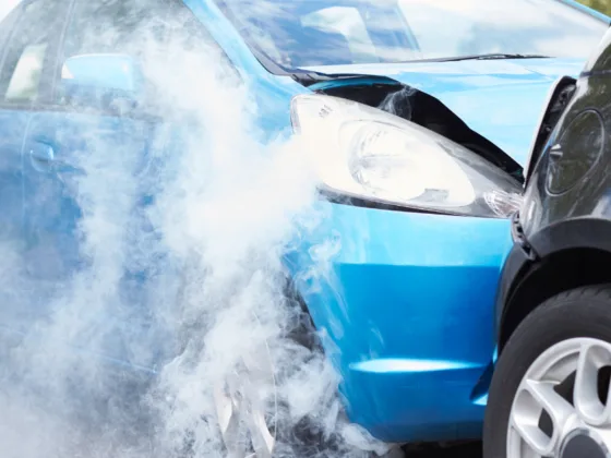 Car write-offs: Two cars involved in a collision, showing front-end damage and smoke rising from one vehicle.